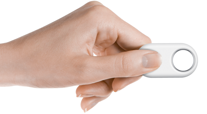 A hand holding out a white smarttag